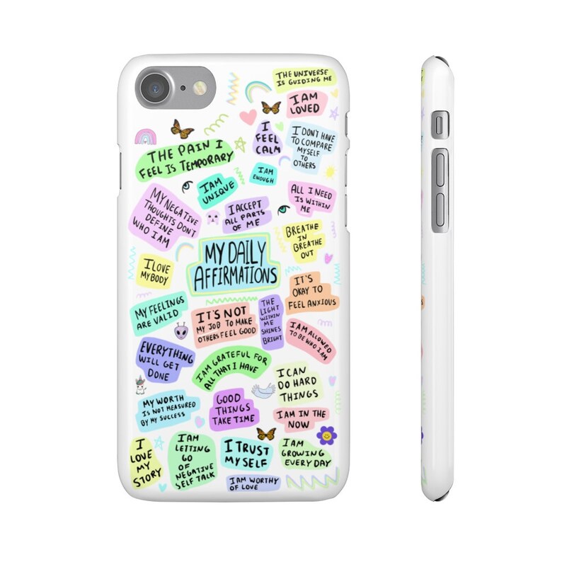 May include: A white iPhone case with a colorful design featuring positive affirmations and motivational quotes. The text includes phrases like "The pain I feel is temporary", "I am unique", "My daily affirmations", "I am loved", "I am worthy of love", and "I am growing every day".