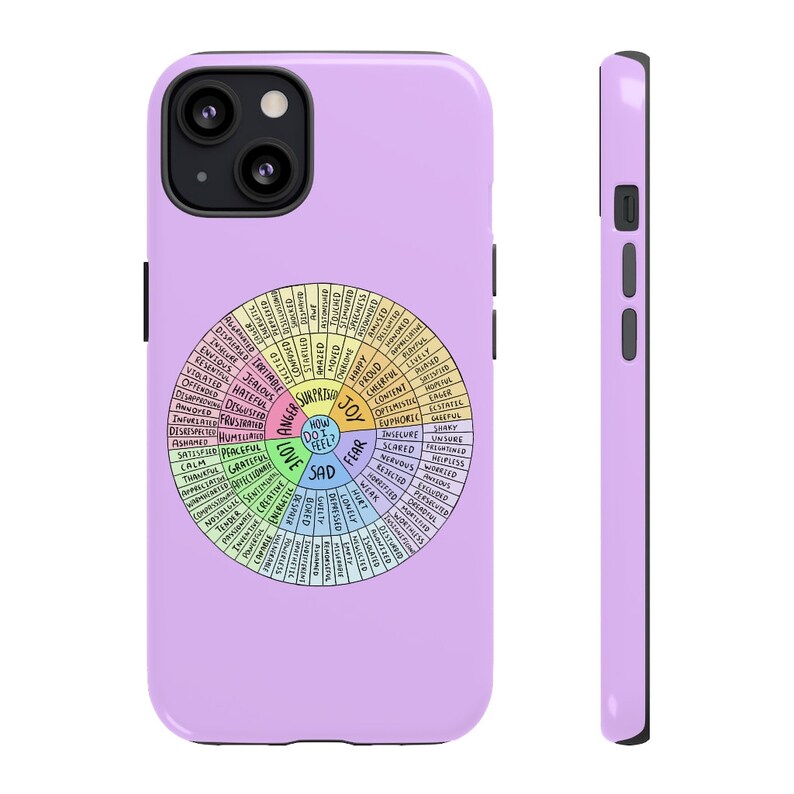 May include: A lavender phone case featuring a colorful emotion wheel design. The wheel is divided into sections labeled with various feelings, such as joy, sadness, and anger. The case has a smooth finish and a black border.