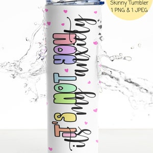 May include: White skinny tumbler with the text "It's not my anxiety" in rainbow colors and pink hearts. The tumbler is in a splash of water.
