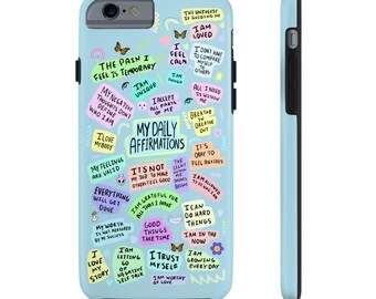 May include: A light blue phone case with a colorful design featuring positive affirmations and motivational quotes. The text includes phrases like "I am loved", "My daily affirmations", "The pain I feel is temporary", and "I am worthy of love".