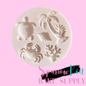 May include: A round white silicone mold featuring five recessed tropical designs: a sea turtle, a palm tree, a seashell, a crab, and a piece of coral. The text Sparrow Kin BAKE SUPPLY is printed in pink and black at the bottom of the image.