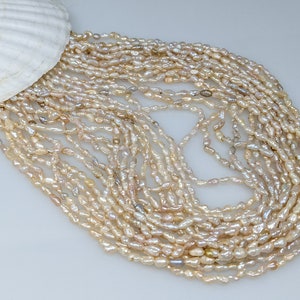 Cream Chinese freshwater Rice Krispy pearls  2.5 -3.0 by 7-8mm pearl strand