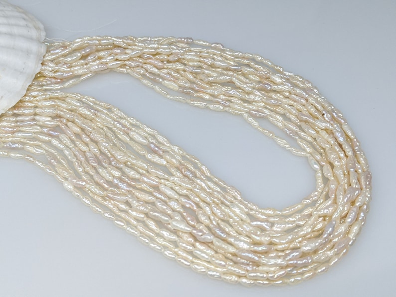 Cream Chinese Freshwater Long Rice Krispies 2.5-3.0 by 8.5mm pearl strand