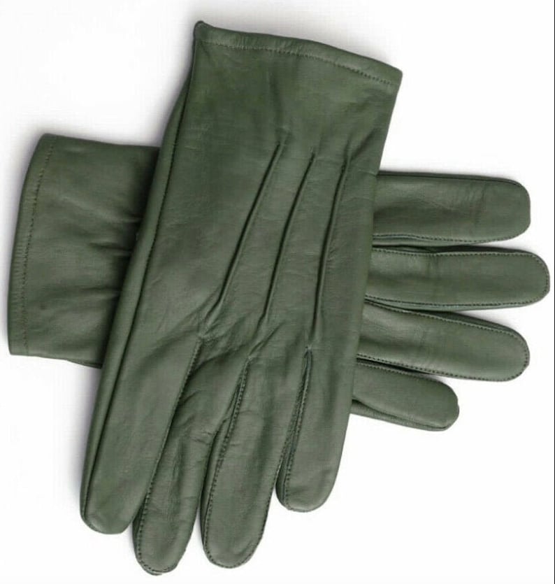 May include: A pair of green leather gloves. The gloves are folded in half, with the fingertips of one glove extending beyond the other.