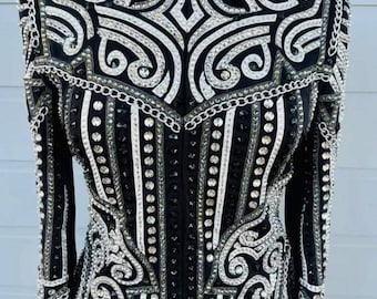 May include: A black and white show jacket with a silver chain design and rhinestones.