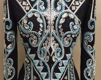 May include: A black show jacket with a turquoise and silver geometric design. The jacket has a zipper closure and long sleeves.