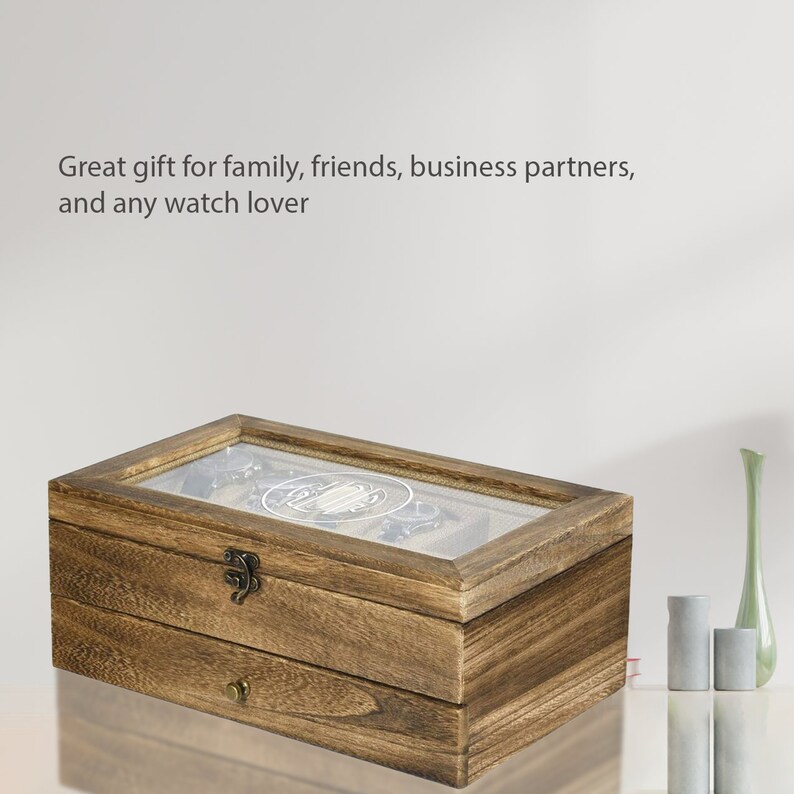 May include: A wooden watch box with a glass top and a drawer. The box is brown and has a rustic look. It is a great gift for watch lovers.