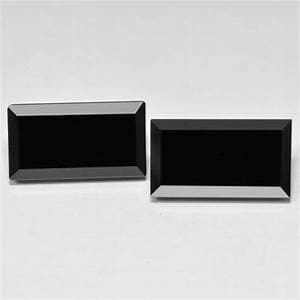 Puede incluir: Dos piedras preciosas rectangulares de ónix negro con bordes biselados se muestran sobre un fondo blanco. Las piedras están pulidas y reflejan la luz, mostrando sus superficies oscuras y brillantes. Las piedras son de tamaño y forma similares, perfectas para la fabricación de joyas.