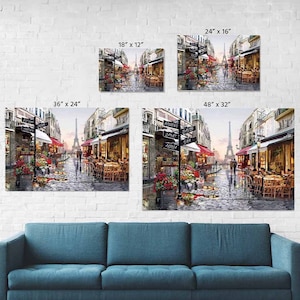 May include: A painting of a Parisian street scene with the Eiffel Tower in the background. The street is lined with shops and cafes, and there are people walking and sitting outside. The painting is in a variety of colors, including red, white, blue, and green.