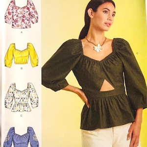 May include: Simplicity pattern R11764 for women's tops, featuring different designs with various sleeve and neckline styles. The image shows a woman wearing a dark green top with a cutout. The pattern size is U.S. 8-16, Euro 34-42, and French 36-44.