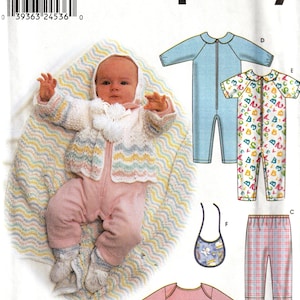 May include: Simplicity sewing pattern 9493 for infant clothing, including a hooded jacket, rompers, bib, trousers, and shirts. The cover features a baby wearing a white knit jacket with pastel wavy stripes, a pink romper, and matching booties.