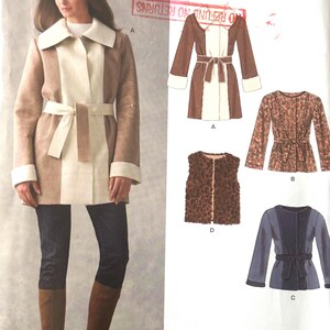 May include: A New Look sewing pattern showing a belted coat and other clothing items. The coat is tan and cream with a matching belt. Other designs include a vest and tops. The pattern size is A 10-22.