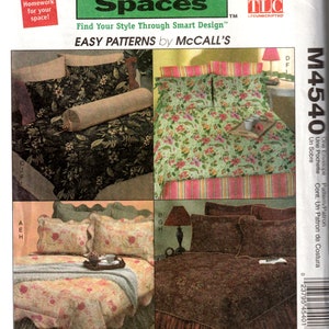 May include: A sewing pattern for a bedspread, pillowcases, and an envelope pillow. The pattern is from McCall's and is called "Trading Spaces". The pattern is for a floral design with a green, pink, and white color scheme.