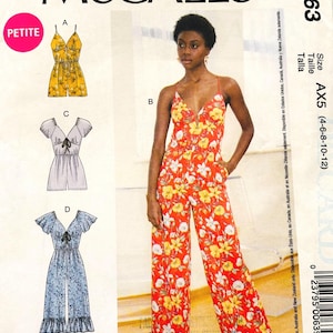 May include: McCall's M7963 sewing pattern envelope featuring Laura Ashley designs. The front displays illustrations of four jumpsuit variations, including a yellow floral romper and a red floral jumpsuit with wide legs and thin straps.
