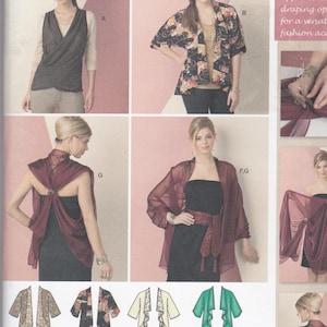 May include: Simplicity sewing pattern 1588A featuring various draped fabric designs. The pattern includes options for jackets, wraps, and a vest. The image shows models wearing the finished garments, showcasing different styles and colors.