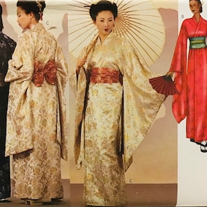 May include: A sewing pattern envelope featuring illustrations of kimonos in various colours and patterns, including a dark blue, a cream, a red, and a black version, each with wide sleeves, obi sashes, and traditional accessories like fans and umbrellas.