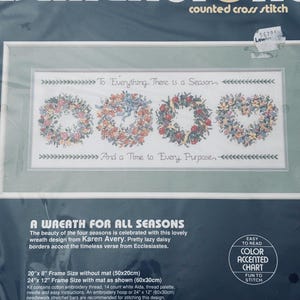 May include: A counted cross stitch kit with a design of four floral wreaths, each representing a season. The text "To Everything There is a Season" and "And a Time to Every Purpose" are included. The frame size is 50cm x 20cm without a mat.