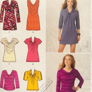 May include: A Simplicity sewing pattern envelope 1710 P5 featuring illustrations of six different dress and top designs with various necklines and sleeve lengths, alongside photographs of two finished garments in purple and magenta hues.