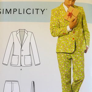 May include: A Simplicity sewing pattern showing a green suit with a floral design. The pattern includes a blazer, trousers, and tie. The image also shows a person wearing the suit and holding a gift box.
