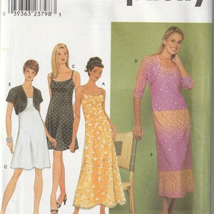 May include: A sewing pattern for a dress with a floral print, a polka dot print, and a plain colour. The pattern includes a separate bolero jacket. The pattern number is 9122 and the size is 6-16.
