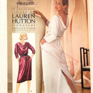 May include: A Simplicity sewing pattern envelope 6641 for a Lauren Hutton signature collection dress. The cover features a white long-sleeved dress with a cowl neckline and a front slit, alongside an illustration of a maroon version of the same dress.