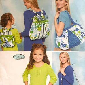 May include: A Simplicity sewing pattern envelope 1824 featuring illustrations of various bags including backpacks and shoulder bags with blue, green, and white floral and striped fabric designs. The pattern includes options for different sizes and styles.