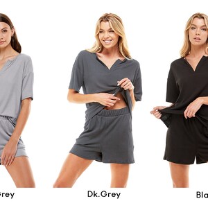 May include: Three women model matching short-sleeved tops and shorts sets in light grey, dark grey, and black.