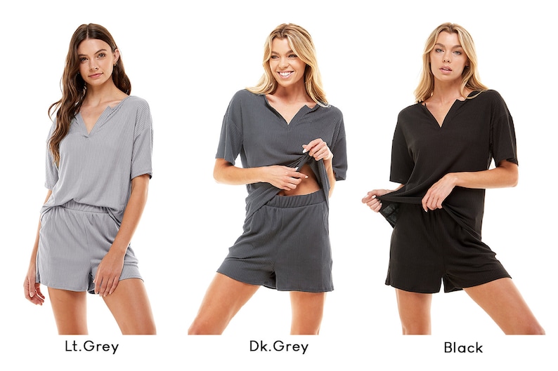 May include: Three women model matching short-sleeved tops and shorts sets in light grey, dark grey, and black.