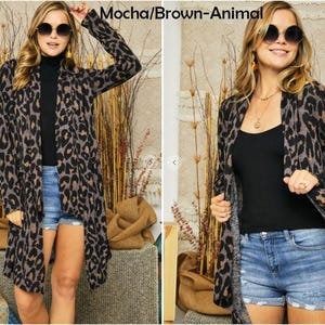 Two views of a blonde model wearing a brown animal print cardigan, black top, and denim shorts, with the text mocha brown animal above.