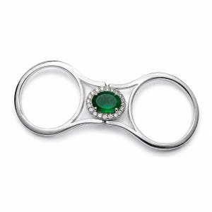 May include: A double-finger ring crafted from polished silver-toned metal, featuring a central oval-cut deep green gemstone surrounded by a halo of small, clear, round-cut stones. The design connects two circular bands with a central bridge.