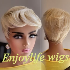 May include: A short blonde wig with a side part and a layered style. The wig is styled in a pixie cut with a side part and a layered style. The wig is on a mannequin head with a yellow shirt. The text "Enjoylife wigs" is visible on the shirt.