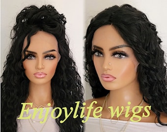 May include: A long, black, curly wig on a mannequin head. The wig is styled with a side parting and loose waves. The mannequin is wearing a white shirt and a gold necklace. The text "Enjoylife Wigs" is visible in the image.