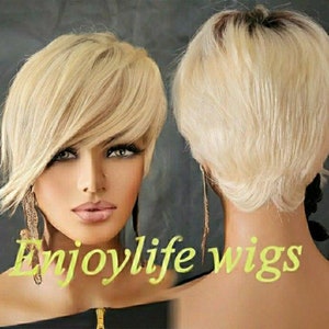 May include: A blonde wig with a short, layered style. The wig is shown from the front and back, with the text "Enjoylife wigs" in a yellow-green font across the bottom of the image.