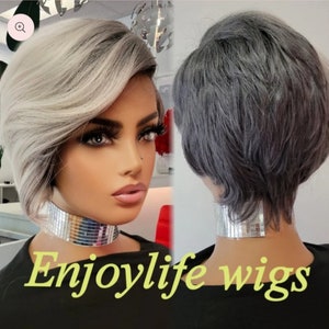 May include: A short, gray and silver wig with a side part. The wig is styled with a side swept bang and layers. The wig is shown on a mannequin head. The text "Enjoylife wigs" is displayed at the bottom of the image.