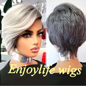 May include: A short, gray and white wig with a side part. The wig is styled with a side swept bang and layers. The wig is on a mannequin head. The text "Enjoylife wigs" is at the bottom of the image.