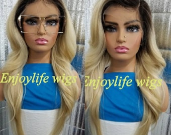 May include: A long, straight blonde wig with dark roots. The wig is styled with a side part and has a natural wave. The wig is worn by a person with a blue shirt and the text "Enjoylife wigs" is visible on the image.