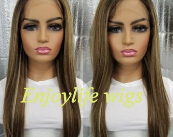 May include: A long, straight, light brown wig with blonde highlights. The wig is styled with a side part and falls to the shoulders. The wig is on a mannequin head.