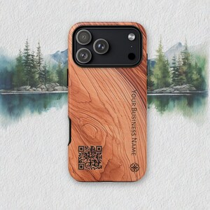 May include: A wooden phone case with a natural wood grain pattern. The case has a black camera module and features the text "YOUR BUSINESS NAME" and a QR code. A compass rose is also visible.
