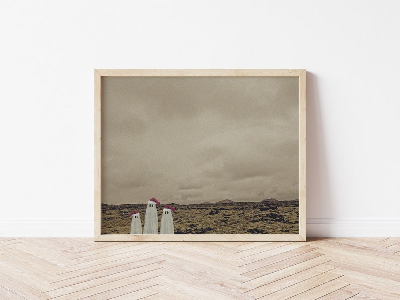May include: A framed print of a landscape with three white ghosts wearing red Santa hats. The ghosts are standing in a field of brown grass with a cloudy sky in the background.