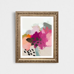 May include: Abstract art print in a gold frame. The print features a colorful abstract design with pink, purple, orange, brown, and black paint strokes.