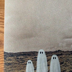 May include: Three white ghosts with black eyes stand in front of a dark, textured background.
