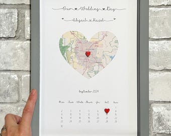 May include: A framed print with a heart-shaped map of a city and a calendar with a red heart marking September 6th. The text above the map reads "Our Wedding Day *Aligail Hazıl*" and the calendar is labeled "September 2024".