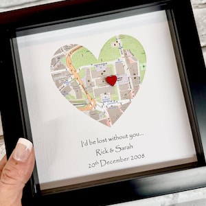 May include: Framed artwork featuring a heart-shaped map with a red heart pin. The artwork includes the text "I'd be lost without you... Rick & Sarah 20th December 2008". The frame is black.