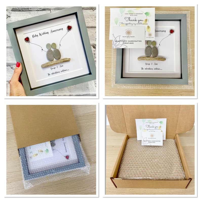 May include: A gray picture frame with a white mat and a pebble art design of two figures holding hands. The art is titled "Ruby Wedding Anniversary" and includes the text "George & Ann... The adventures continue..." The frame is packaged in a brown cardboard box with bubble wrap.