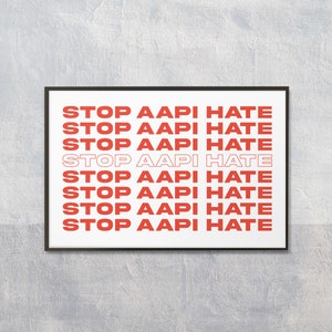 May include: A black framed poster with the text "STOP AAPI HATE" repeated eight times in red and white lettering.