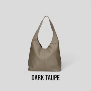 May include: A dark taupe leather tote bag with a slouchy, unstructured design.