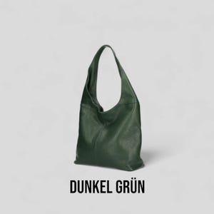 May include: A dark green leather tote bag with a single strap. The bag is made of soft, textured leather and has a simple, classic design.