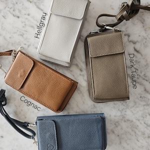 May include: A collection of leather phone crossbody bags in various colors: silver, cognac, dark taupe, and jeans blue. Each bag features a flap closure, a zippered compartment, and a detachable strap. The text on the image indicates the color names.