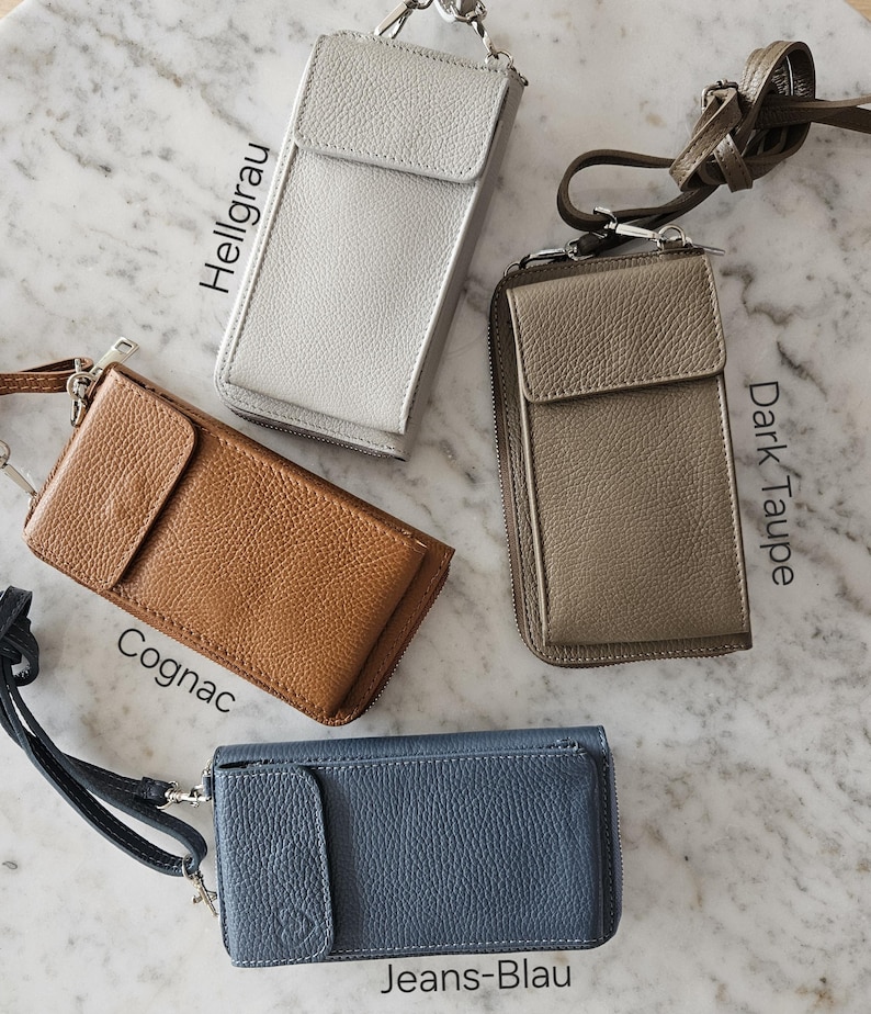 May include: A collection of leather phone crossbody bags in various colors: silver, cognac, dark taupe, and jeans blue. Each bag features a flap closure, a zippered compartment, and a detachable strap. The text on the image indicates the color names.