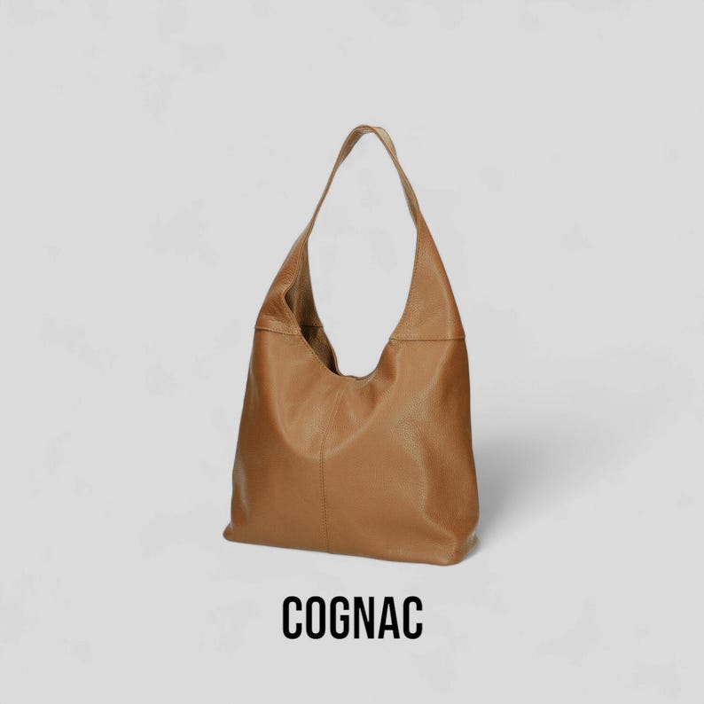 May include: A cognac brown leather hobo bag with a single strap.